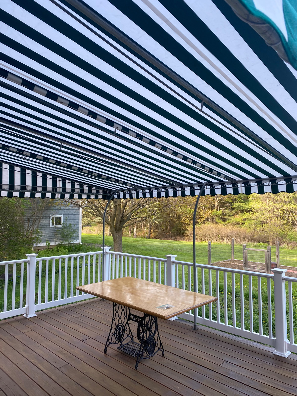 Striped awning over table and deck.